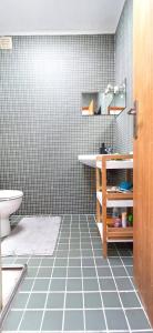 a bathroom with a sink and a tiled floor at Bean House in Vila Nova de Cerveira +23 photos