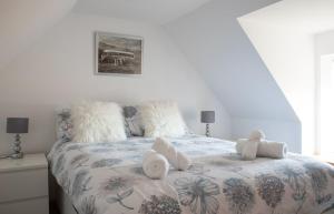 a bedroom with a bed with two towels on it at Ben Edra Croft in Staffin