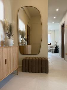 a living room with a large mirror on a wall at Oikiaegina in Egina