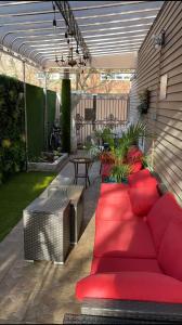 a patio with a red couch and a table at Private Paradise bk in Brooklyn