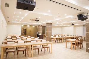 a conference room with tables and chairs and a podium at GRAND OTRADA Hotel Resort & SPA in Odesa +93 photos