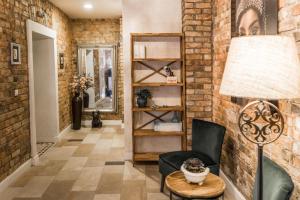 a living room with a brick wall at Stabu Sēta Residence in Riga
