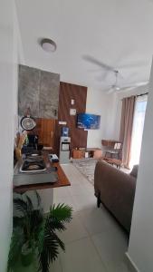 a kitchen and living room with a couch and a table at Bahari Home in Nyali +7 photos