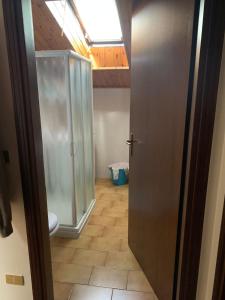 a bathroom with a glass shower and a toilet at Appartamento Edolo in Edolo