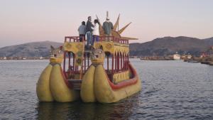 a group of people standing on top of a boat in the water at Uros & Titicaca Sunset Comfort Floating cabins in Puno