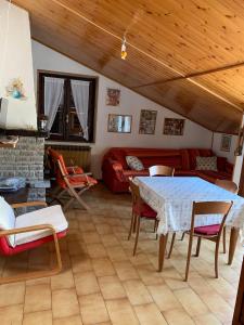 a living room with a table and a couch at Appartamento Edolo in Edolo +8 photos