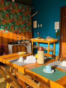 a kitchen with a wooden table with chairs and a stove at Estação Noronha in Fernando de Noronha