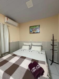 a bedroom with a large bed with two pillows on it at Estação Noronha in Fernando de Noronha