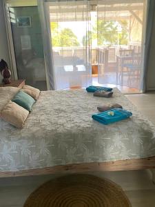 a bedroom with a bed with blue towels on it at Les pieds dans l'eau face au lagon - Le Bel Instant in Sainte-Anne +114 photos