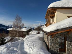 a couple of snow covered roofs of a building at Les Chryolles - Les sources in Valmeinier
