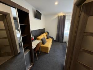 a living room with a couch and a table at Luxury rooms Lira in Ogulin