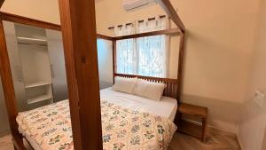 a small bedroom with a bed and a window at Athiratha Living in Malpe