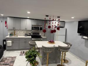 a kitchen with white cabinets and a table with chairs at Private Paradise bk in Brooklyn