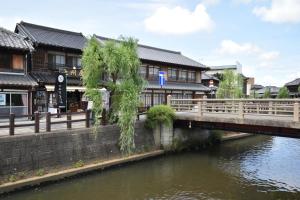 a bridge over a river in a town with buildings at nouveau marche ヌーボーマルシェ in Katori