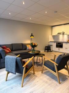 a living room with a couch and a table at Residence Le Mistral in Noordwijk aan Zee