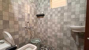 a bathroom with a sink and a toilet at Athiratha Living in Malpe +5 photos