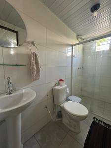 a bathroom with a toilet and a sink at Estação Noronha in Fernando de Noronha +30 photos