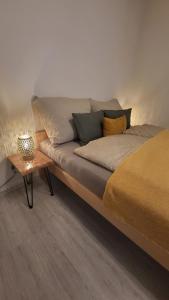 a bed with pillows and a table in a room at Downtown Boho Botanico in Brno