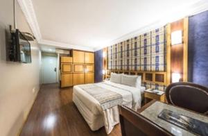 a hotel room with a bed and a television at Monumental Bittar Hotel in Brasília +24 photos