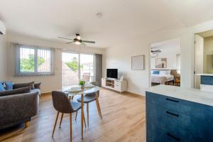 a kitchen and living room with a table and a couch at Bambu Beach Haus Coronado in Las Lajas