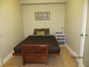 a small bedroom with a bed and a dresser at Kaslo Bay Condominium in Kaslo