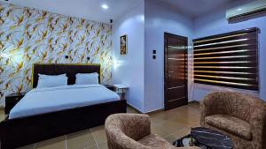 a bedroom with a bed with a fish wall at The Vistana 4Bedroom Pearly Gate Estate Ikota VGC Lekki in Igboshere