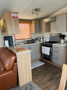 a kitchen with a counter and a stove top oven at Maneight Retreat with Hot tub in New Cumnock