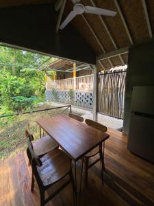 a wooden table and chairs in a room at Seenau House Bali in Selemadeg