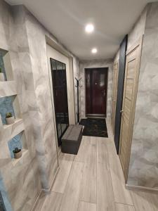 a hallway of a home with a door and a staircase at Agnes Apartament in Valmiera