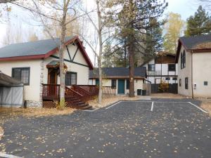 a house with a parking lot in front of it at Castle Wood Theme Cottages- COUPLES ONLY in Big Bear Lake