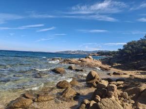 a group of rocks on the shore of the ocean at Casa Mene' in Arzachena