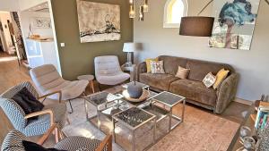 a living room with a couch and chairs at Les Geais - Marevalande in Sainte-Maxime +12 photos