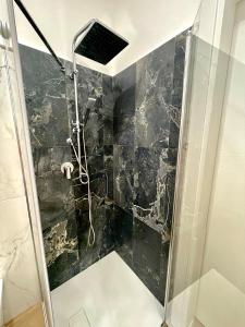 a shower with a glass door in a bathroom at Casa Vacanza Regina in Scalea