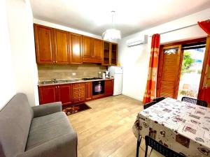 a kitchen with a couch and a table in a room at Casa Vacanza Regina in Scalea