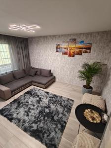 a living room with a couch and a table at Agnes Apartament in Valmiera