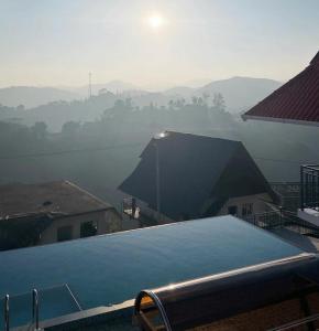 a view of a roof of a house in the fog at Samudra Retreats Vagamon in Vagamon