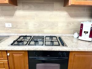 a stove top oven in a kitchen next to a counter at Casa Vacanza Regina in Scalea +2 photos