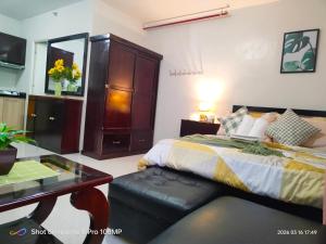 a bedroom with a bed and a table and a desk at Sugarland Urban Nook in Bacolod