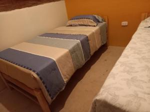 two beds sitting next to each other in a room at Lucmabamba Cabaña de los Duendes in Sahuayacu