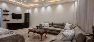 a living room with a couch and a tv at cozy home in Jerash