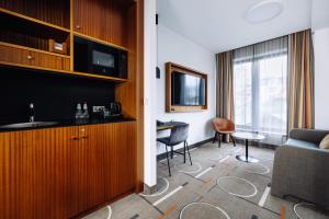 a hotel room with a couch and a table at Hestia Hotel Kentmanni in Tallinn