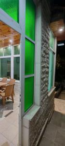a green wall on the side of a building at cozy home in Jerash