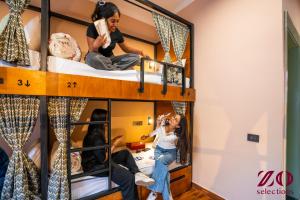 a group of girls sitting on bunk beds at Zo Selections Jaipur by Zostel in Jaipur