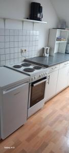 a kitchen with a stove and a counter top at Schneiderhof in Steinbach