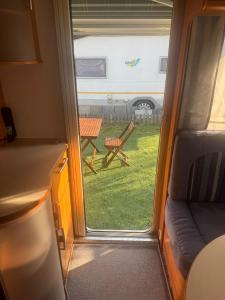 a view from the inside of a trailer with a window at Camping Alex in Cadenazzo