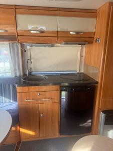 a kitchen in an rv with a sink at Camping Alex in Cadenazzo