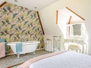 a bedroom with a bath tub and a wall mural at 2 Bed in Westerham oc-88626 in Westerham