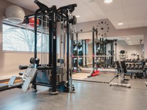 a gym with several treadmills and machines at Rönneberga in Lidingö