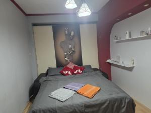 a bedroom with a bed with towels on it at MBM Apartman in Bitola