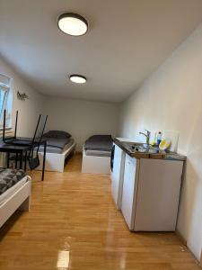 a room with two beds and a kitchen with a counter at Monteurwohnung Viernheim in Viernheim